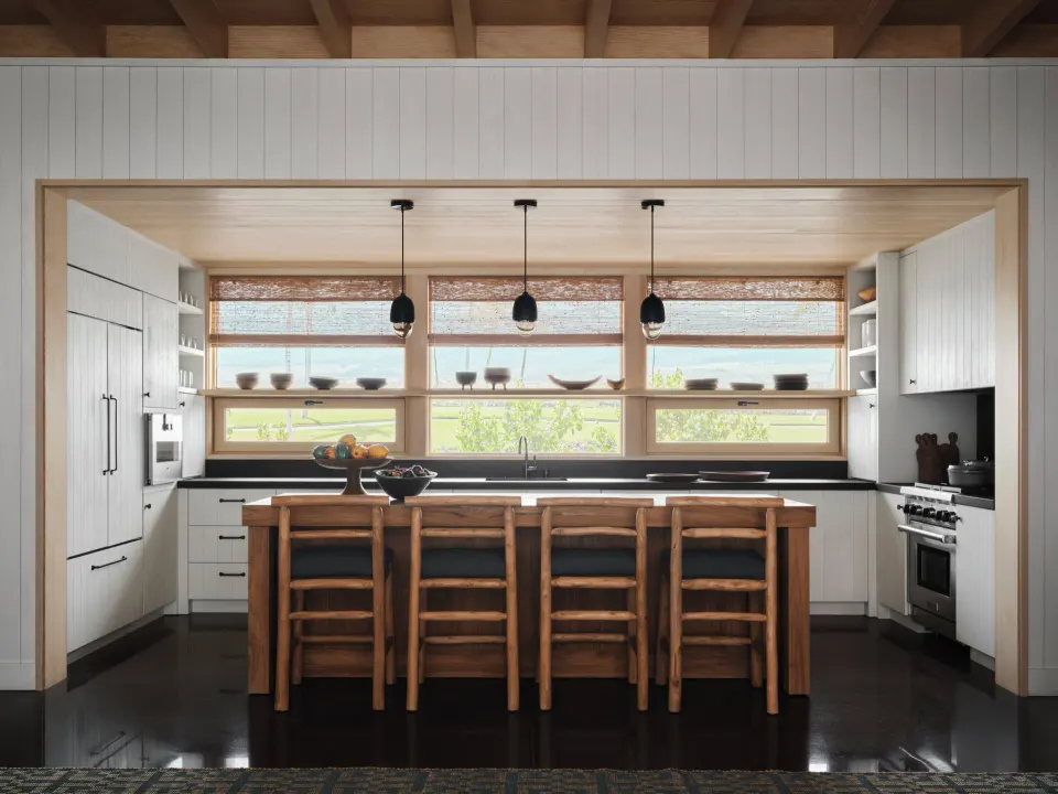 Kitchen with island seating in the Ohana Pool Accessible Four Bedroom Kauhale at Kona Village.