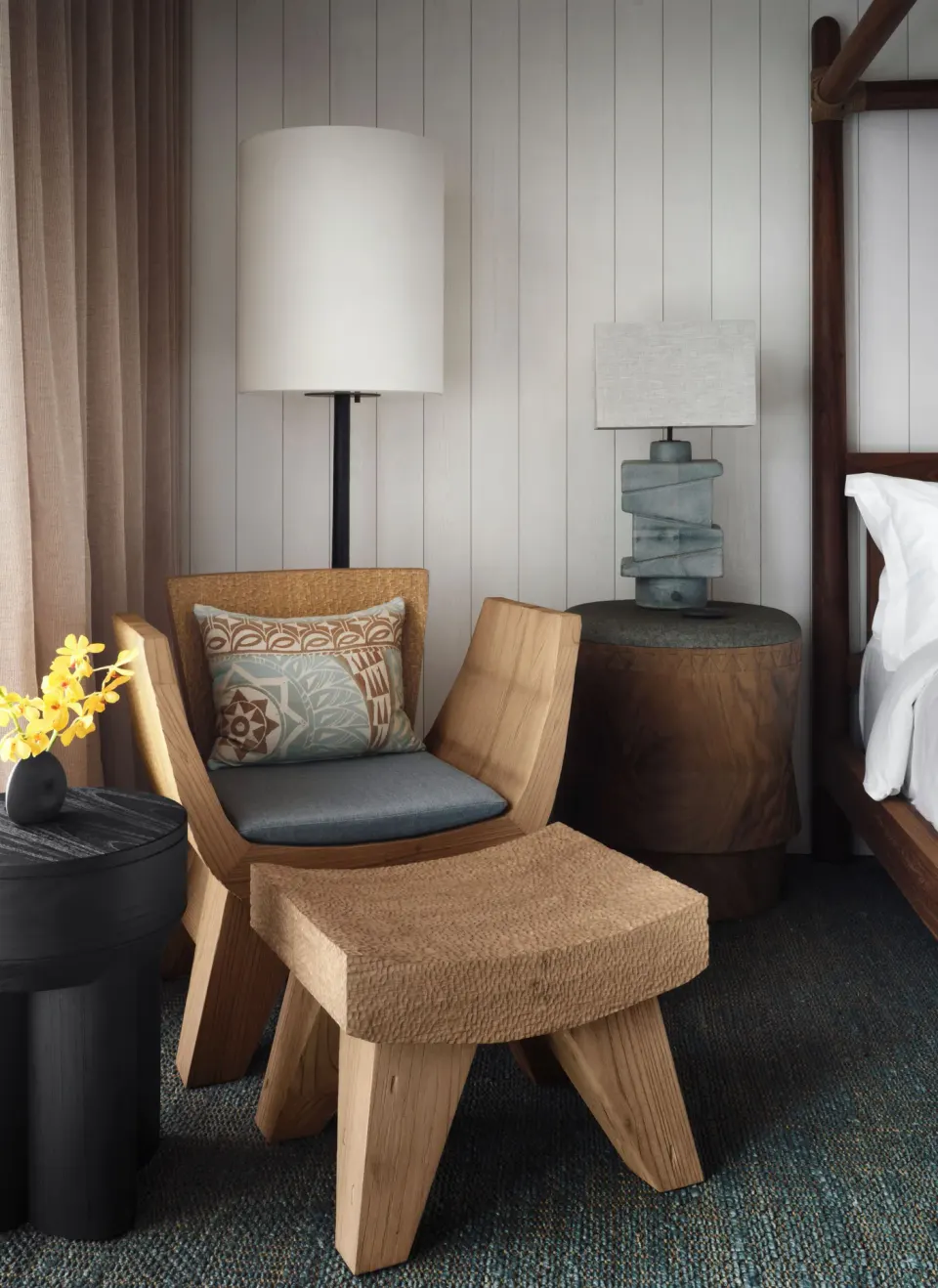 Lounge chair, ottoman, and bedside lighting in a Kona Village guest room.
