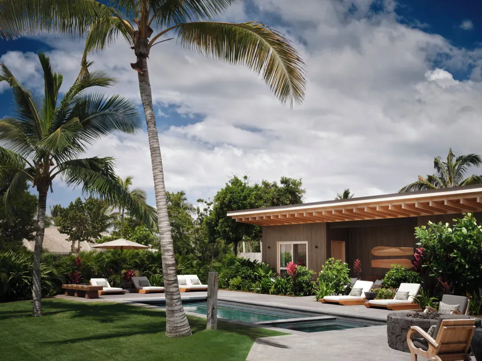 Exterior pool terrace at the Ohana Pool Accessible Four Bedroom Kauhale at Kona Village.