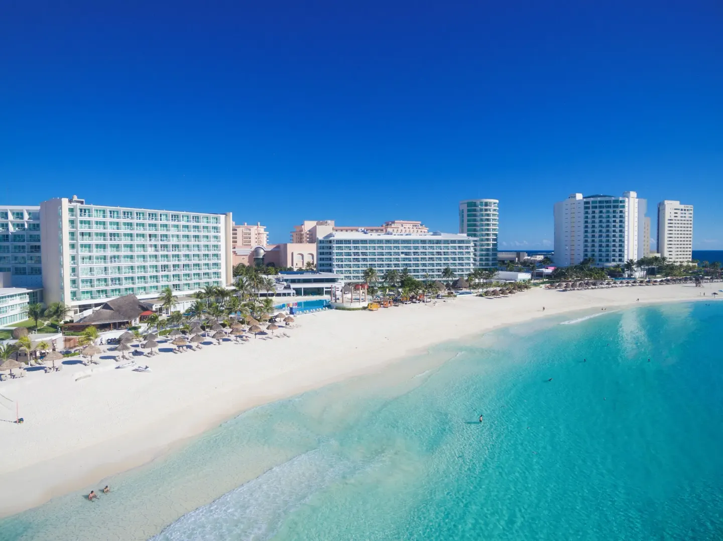 Aerial view of Krystal Cancun on a white-sand beach with turquoise water.