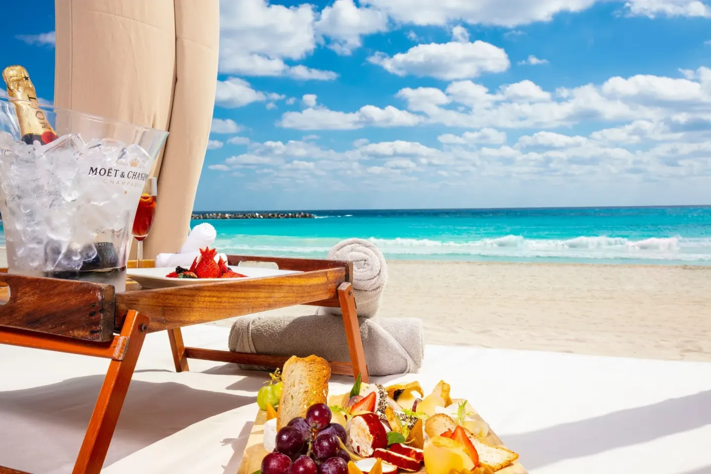 Beach cabana with fruit, towels, and iced sparkling wine at Krystal Cancun.