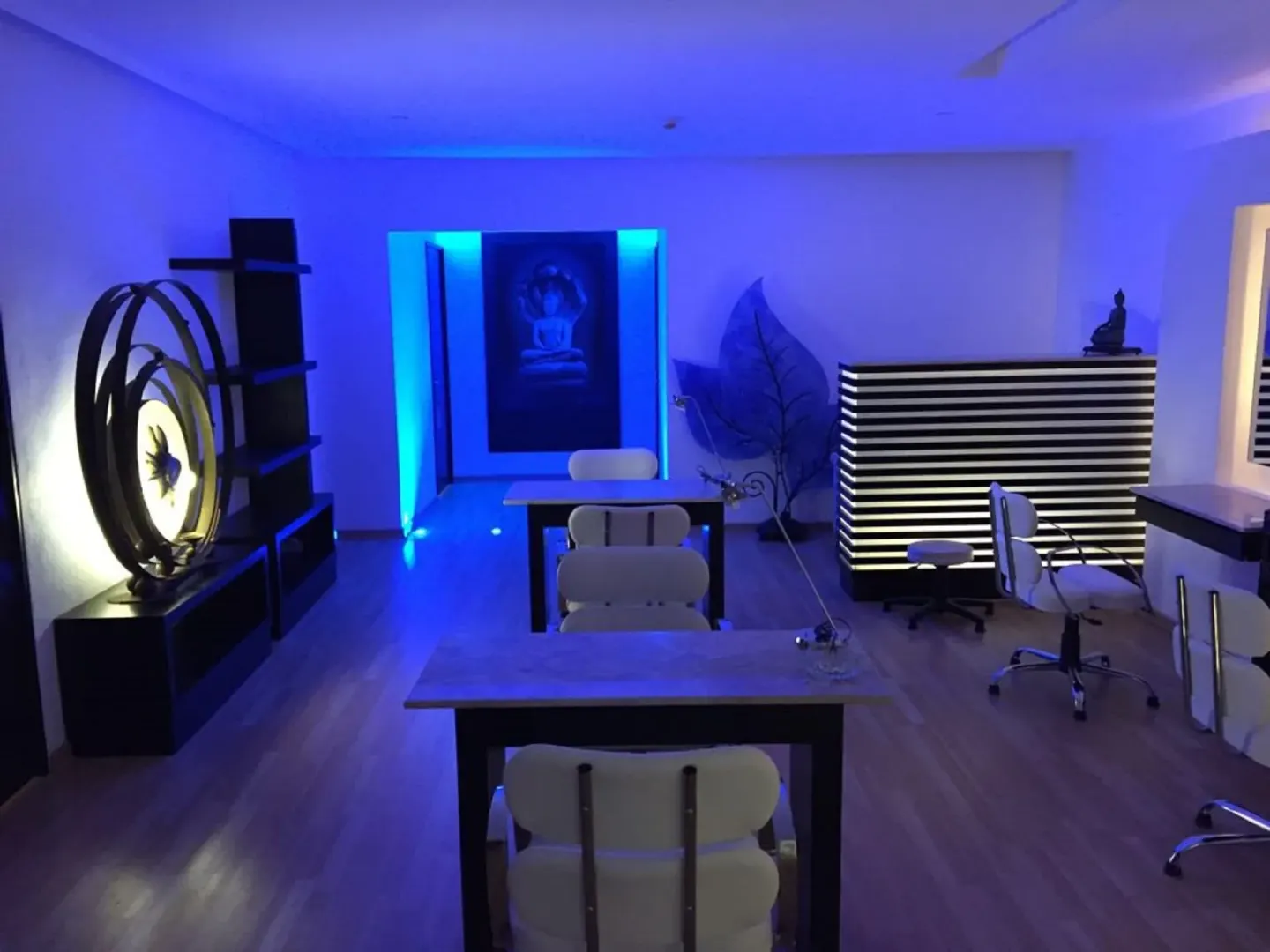 Blue-lit spa reception and treatment stations at Krystal Cancun.