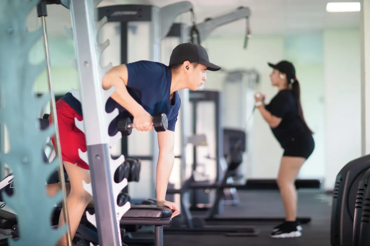 Guests exercise with weights and fitness machines at Krystal Cancun.