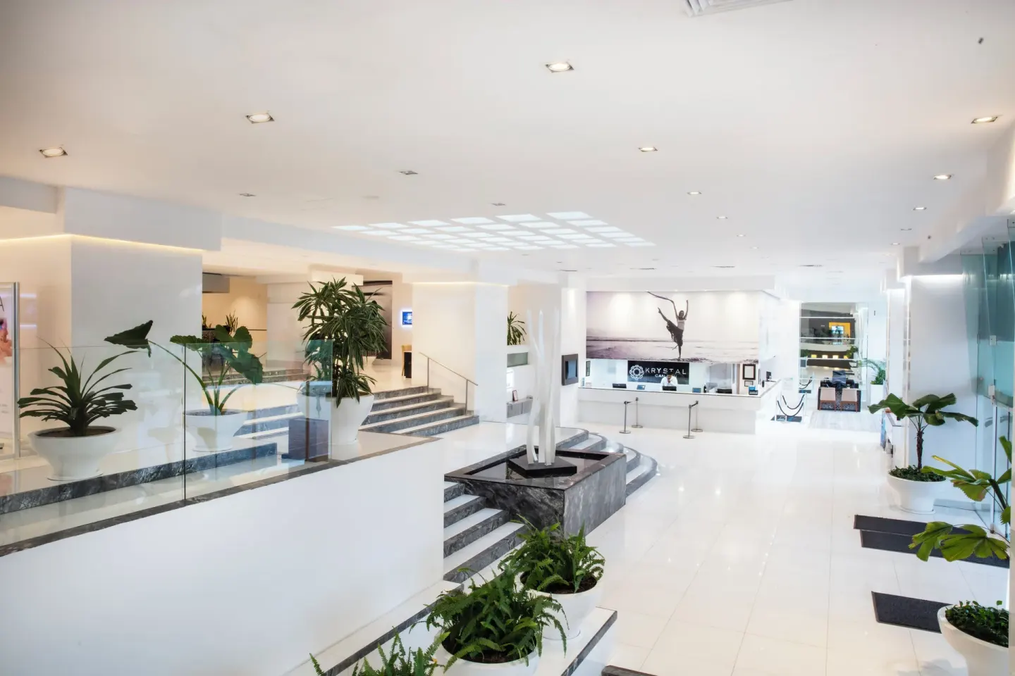 Elevated view of the white lobby and reception desk at Krystal Cancun.