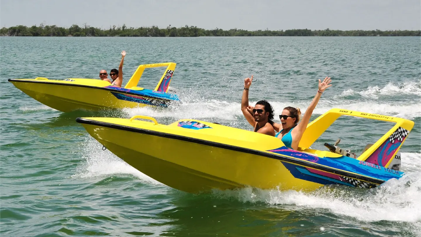 Guests riding yellow speedboats on the water near Krystal Cancun.