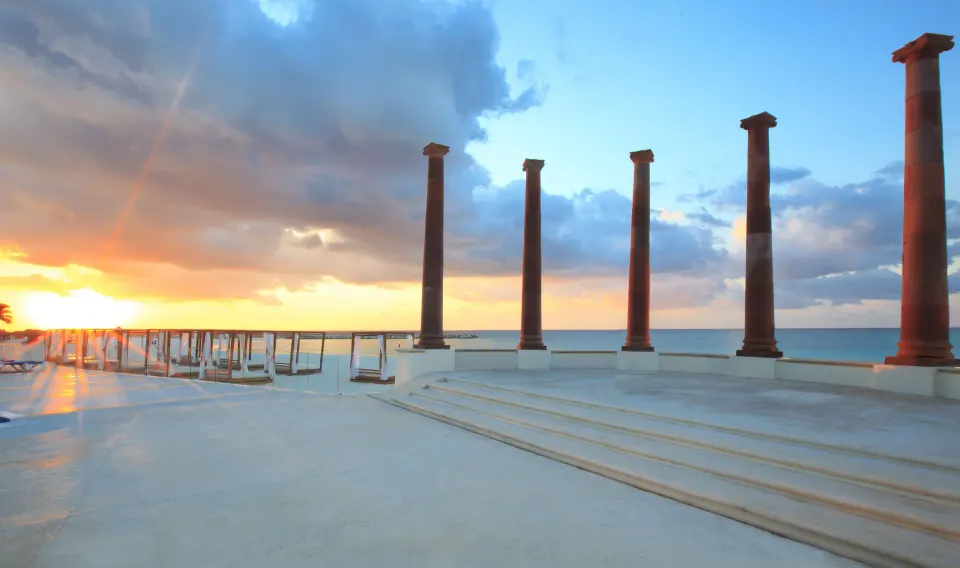 Oceanfront terrace with columns at sunset at Krystal Cancun.