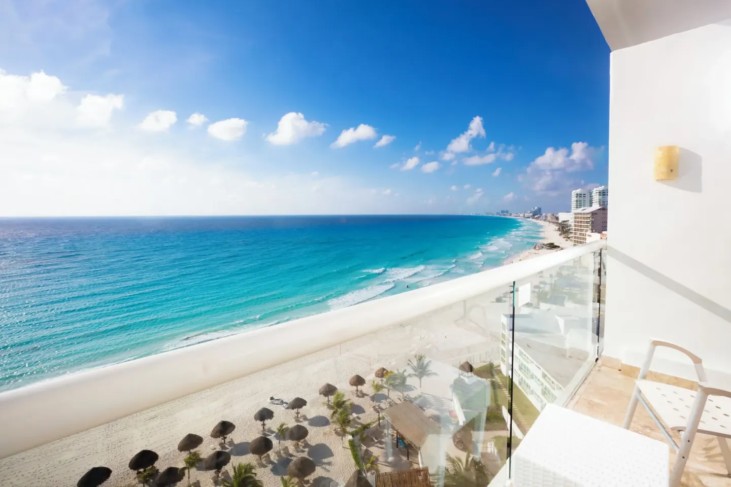 Club Room balcony with chairs and sweeping beach ocean view at Krystal Cancun.