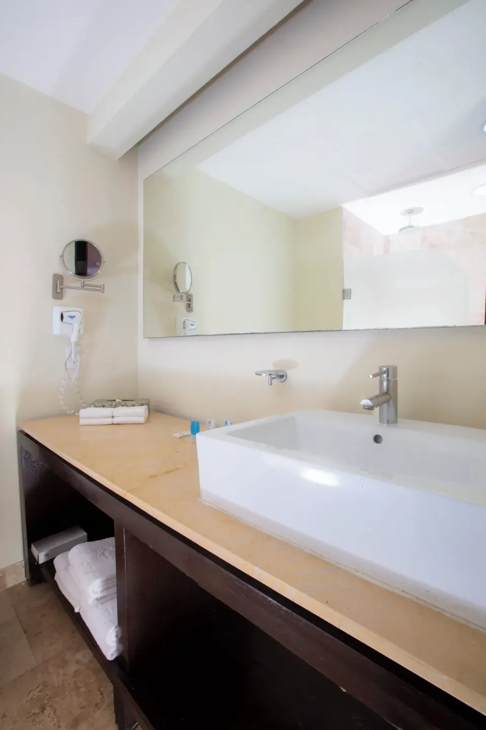 Club Room bathroom vanity with sink and mirror at Krystal Cancun.