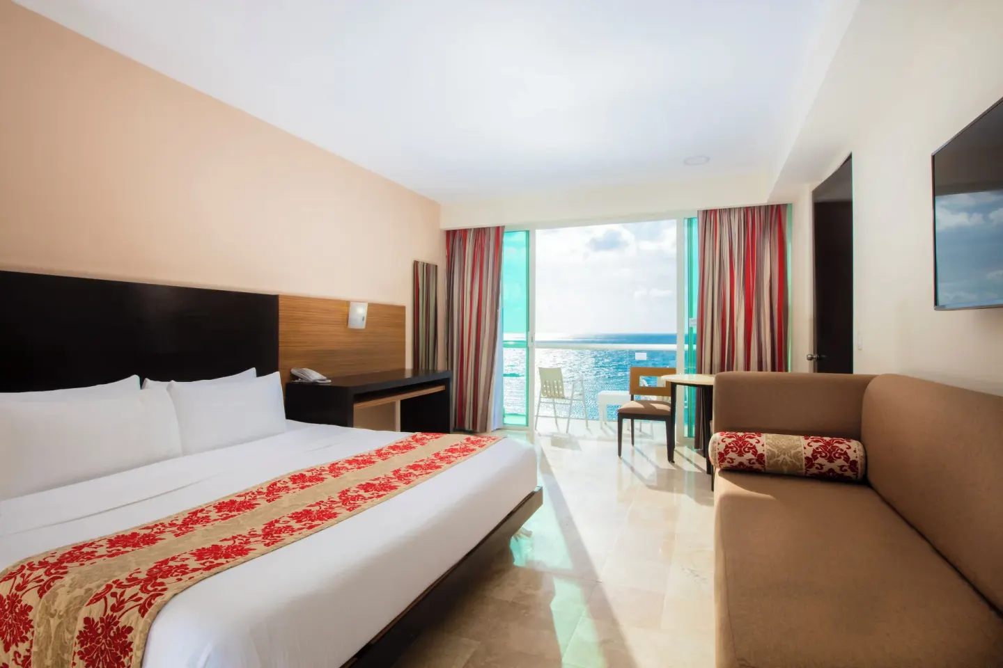 Club Room with king bed, sofa, and balcony ocean view at Krystal Cancun.