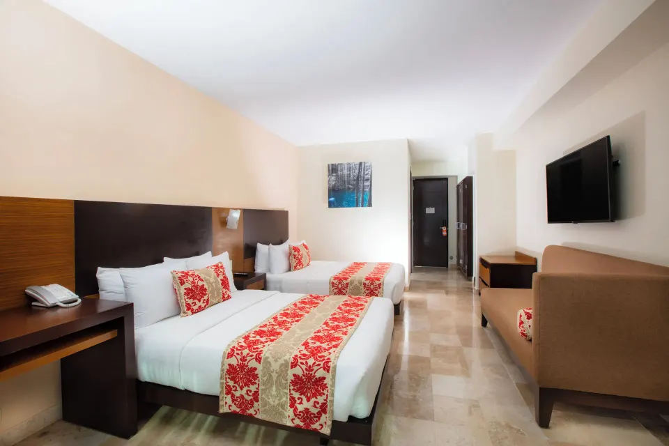 Club Room with two beds, sofa, TV, and entry area at Krystal Cancun.
