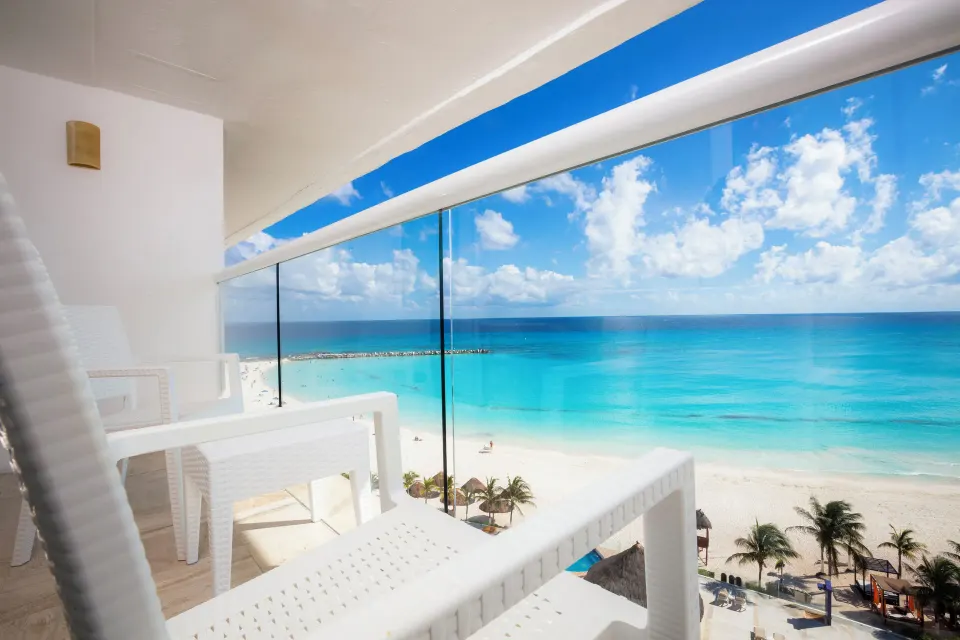 Furnished ocean view balcony overlooking the beach at Krystal Cancun.