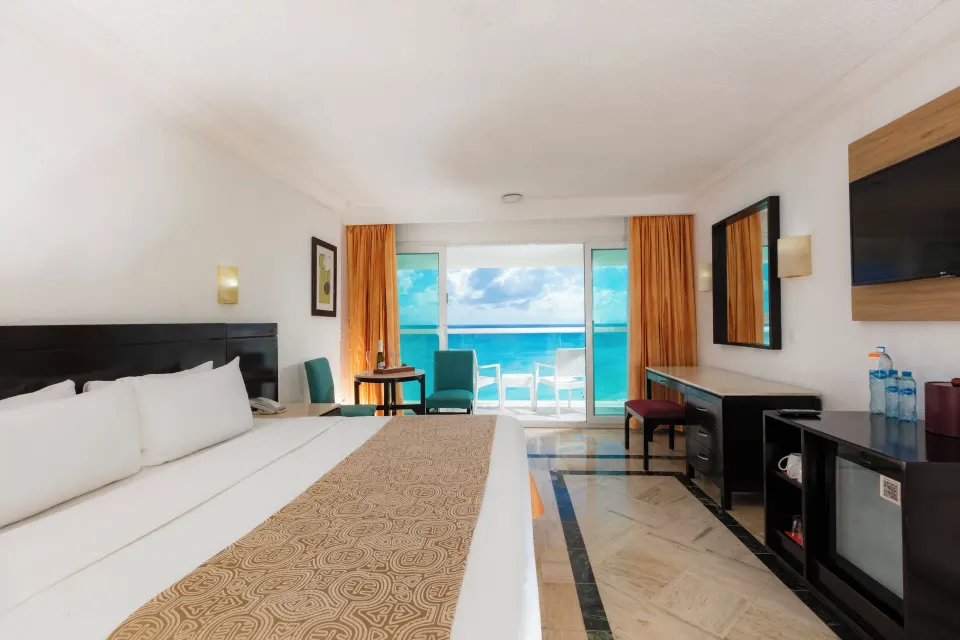 Deluxe ocean view king room with desk and balcony at Krystal Cancun.