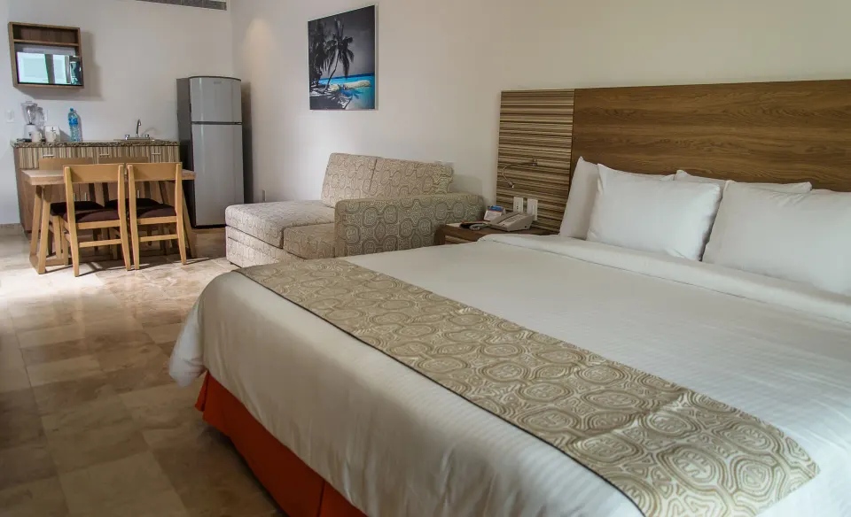 Family Studio bed with sofa bed, dining table, and kitchenette at Krystal Cancun.