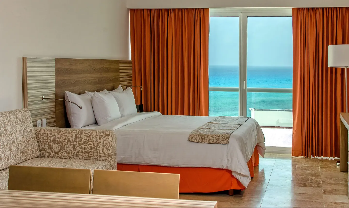 Family Studio bed beside sofa bed and balcony doors with ocean view at Krystal Cancun.
