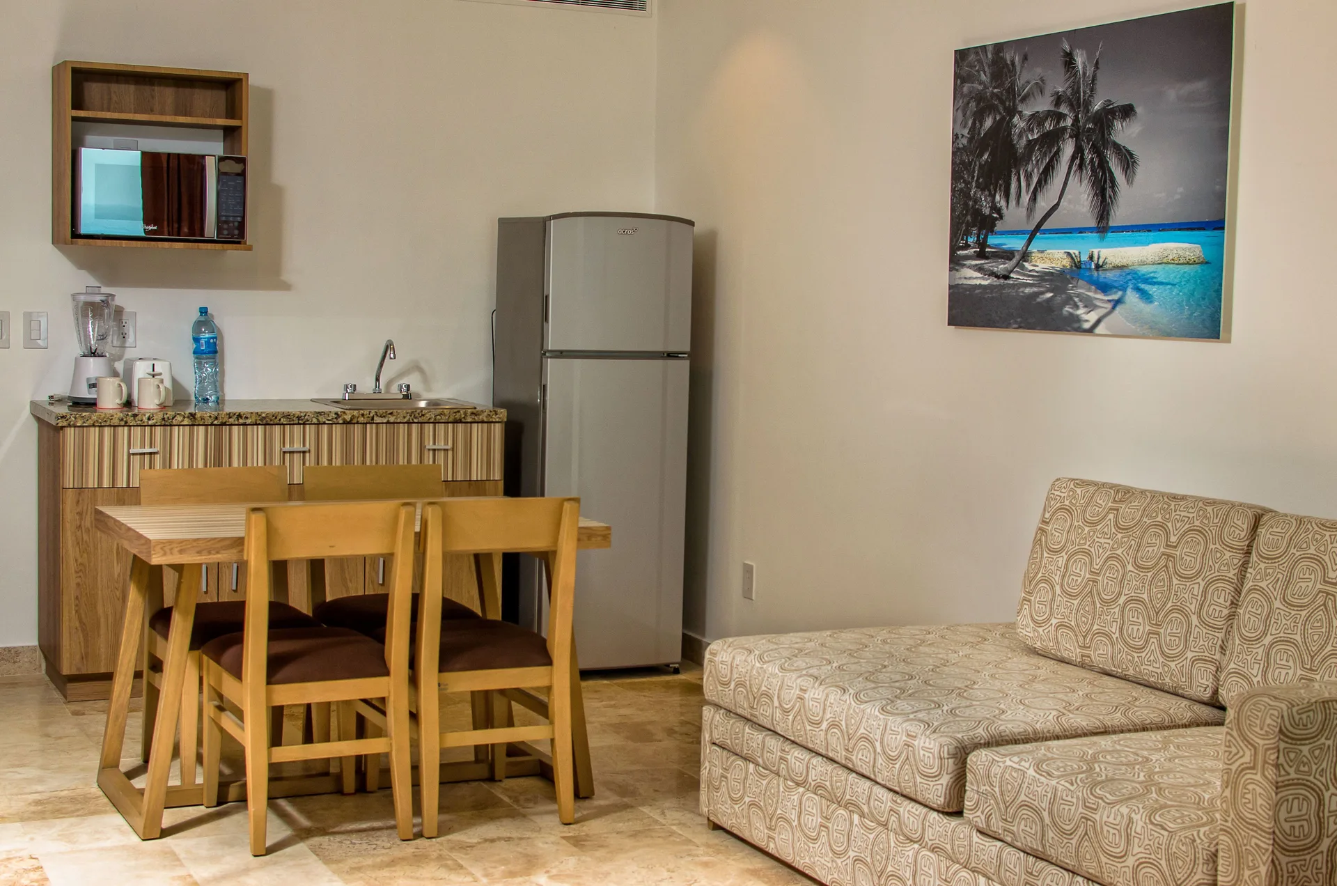 Family Studio kitchenette and sofa bed in a guest room at Krystal Cancun.