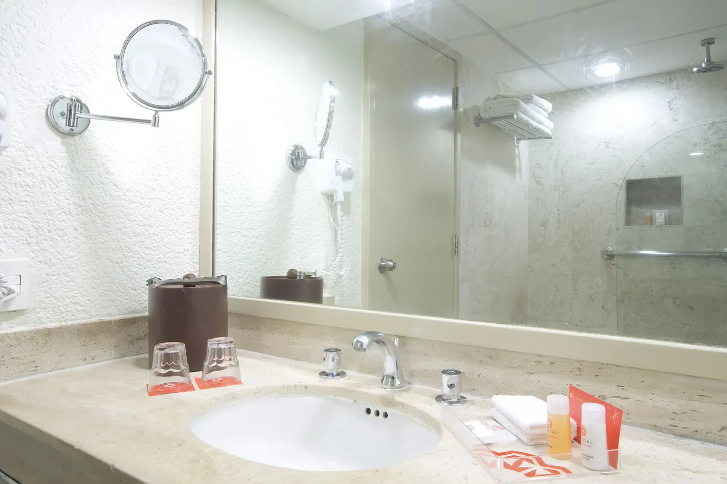 Standard Room City View bathroom vanity and shower at Krystal Cancun.