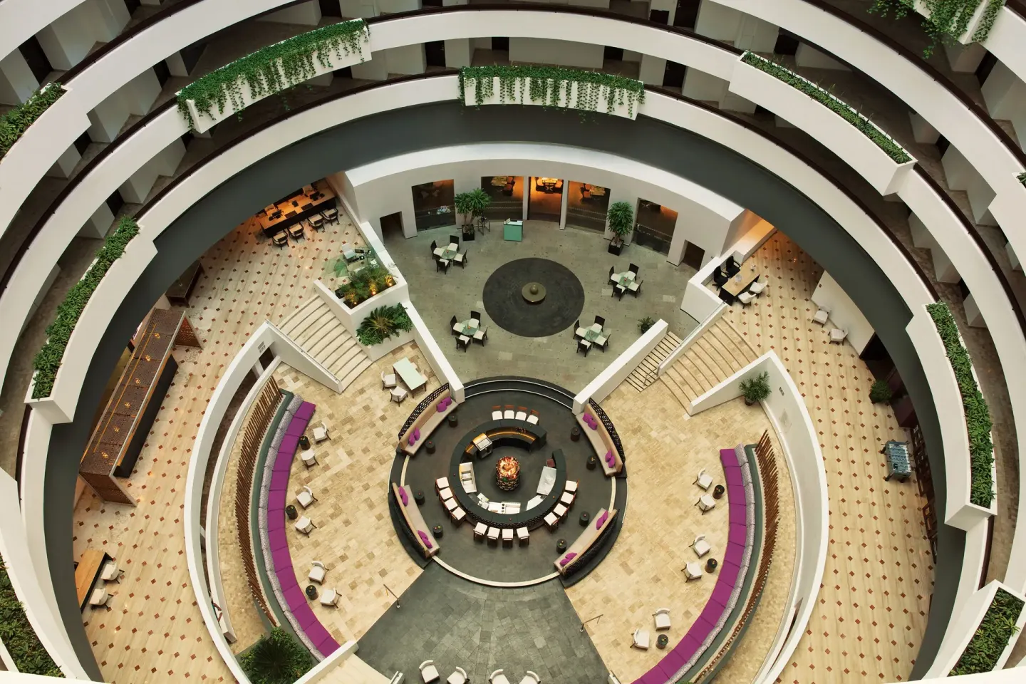 Circular atrium lobby with seating areas inside Krystal Grand Cancun.
