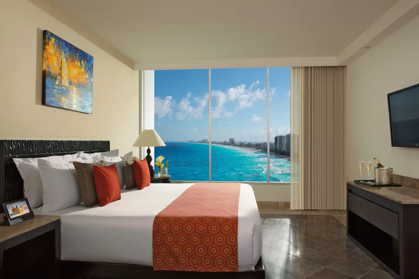 Ocean-view guest room with a king bed and large window at Krystal Grand Cancun.
