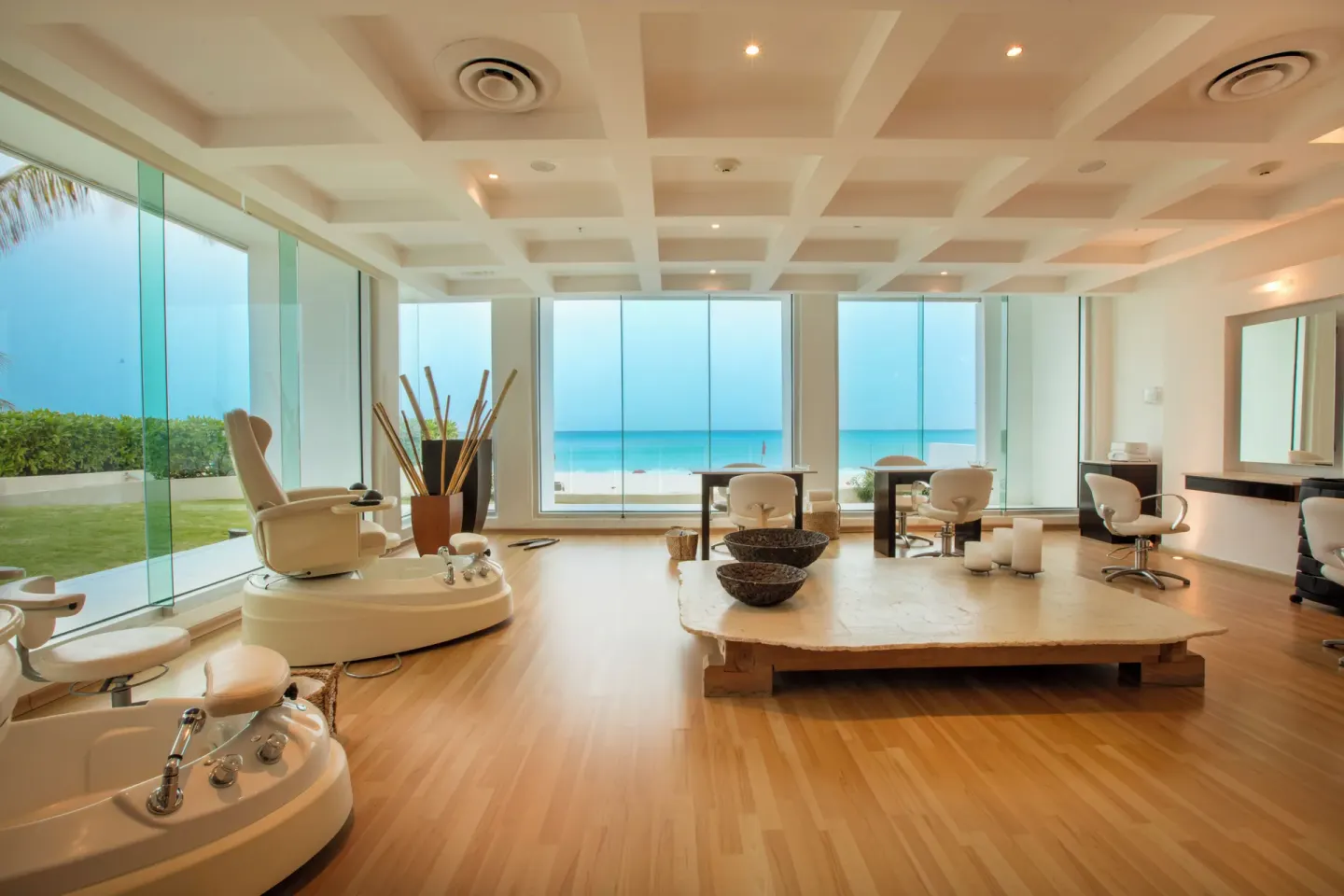 Ocean-view salon pedicure chairs inside the spa at Krystal Grand Cancun.