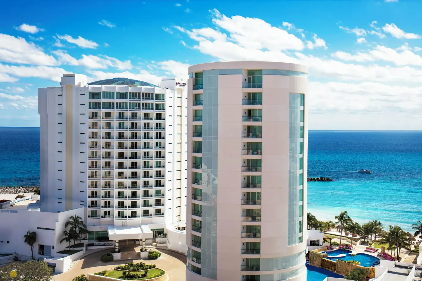 Oceanfront towers and beach beside the pools at Krystal Grand Cancun.