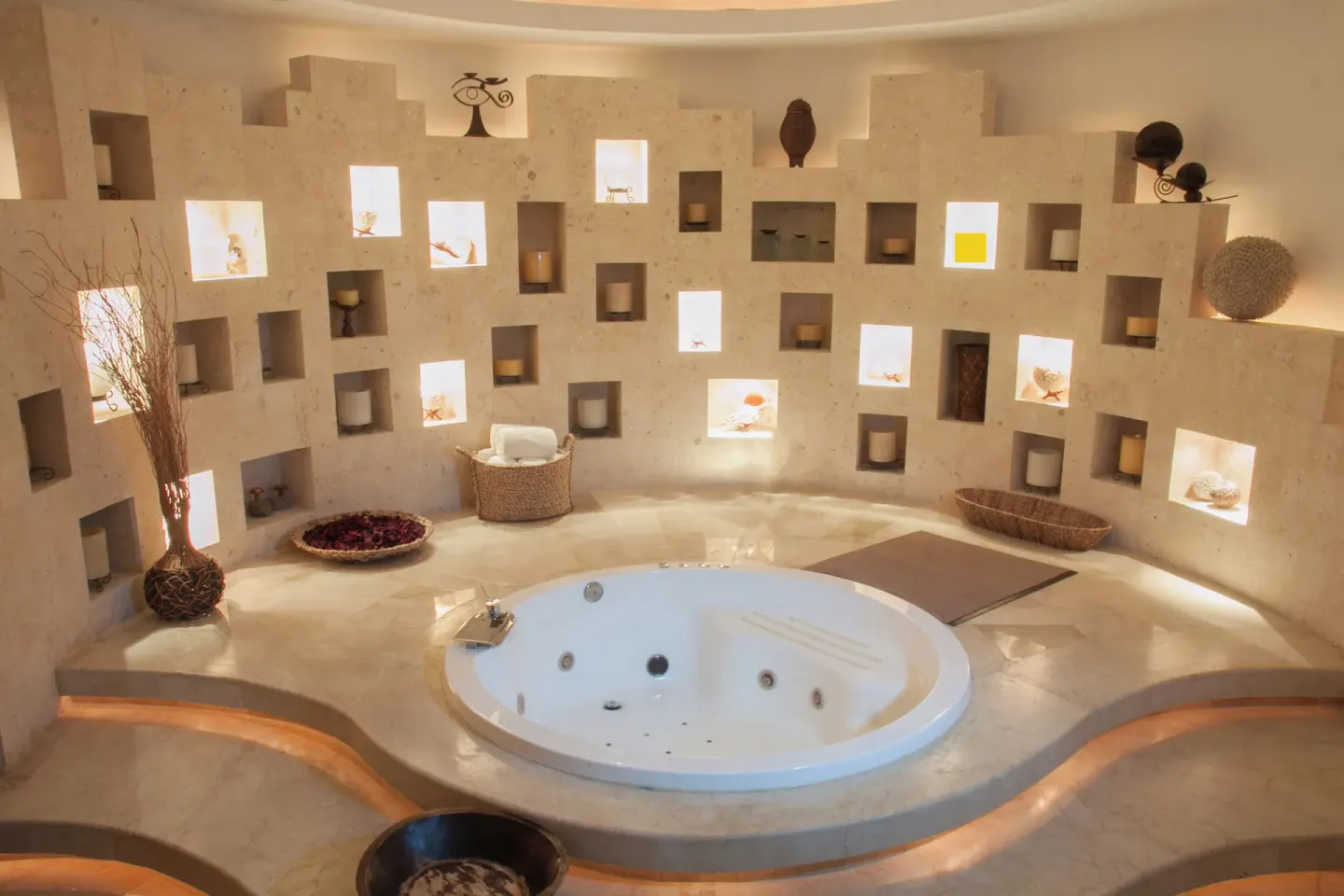 Spa whirlpool room with glowing wall niches at Krystal Grand Cancun.