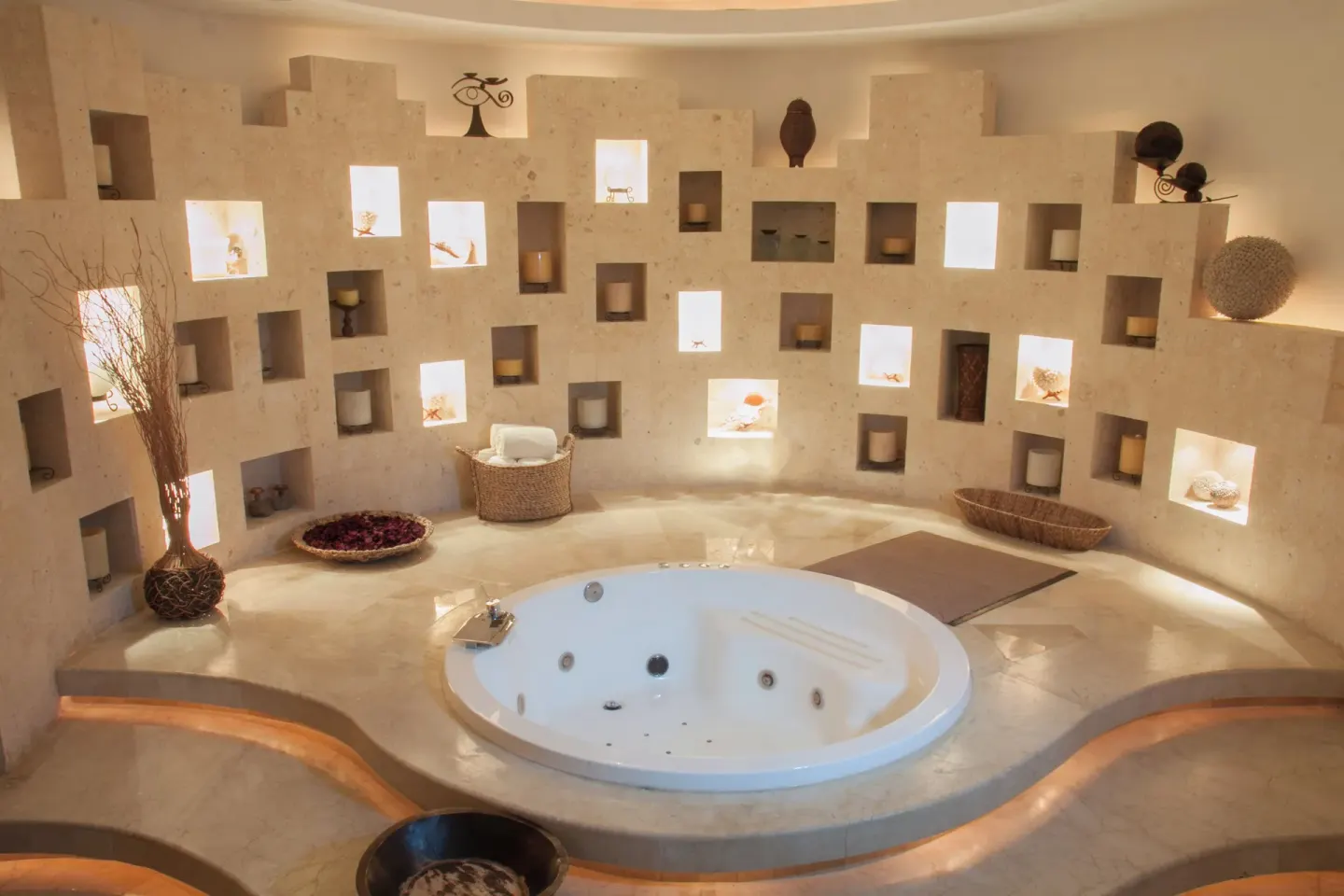 Round spa whirlpool room with illuminated niches at Krystal Grand Cancun.