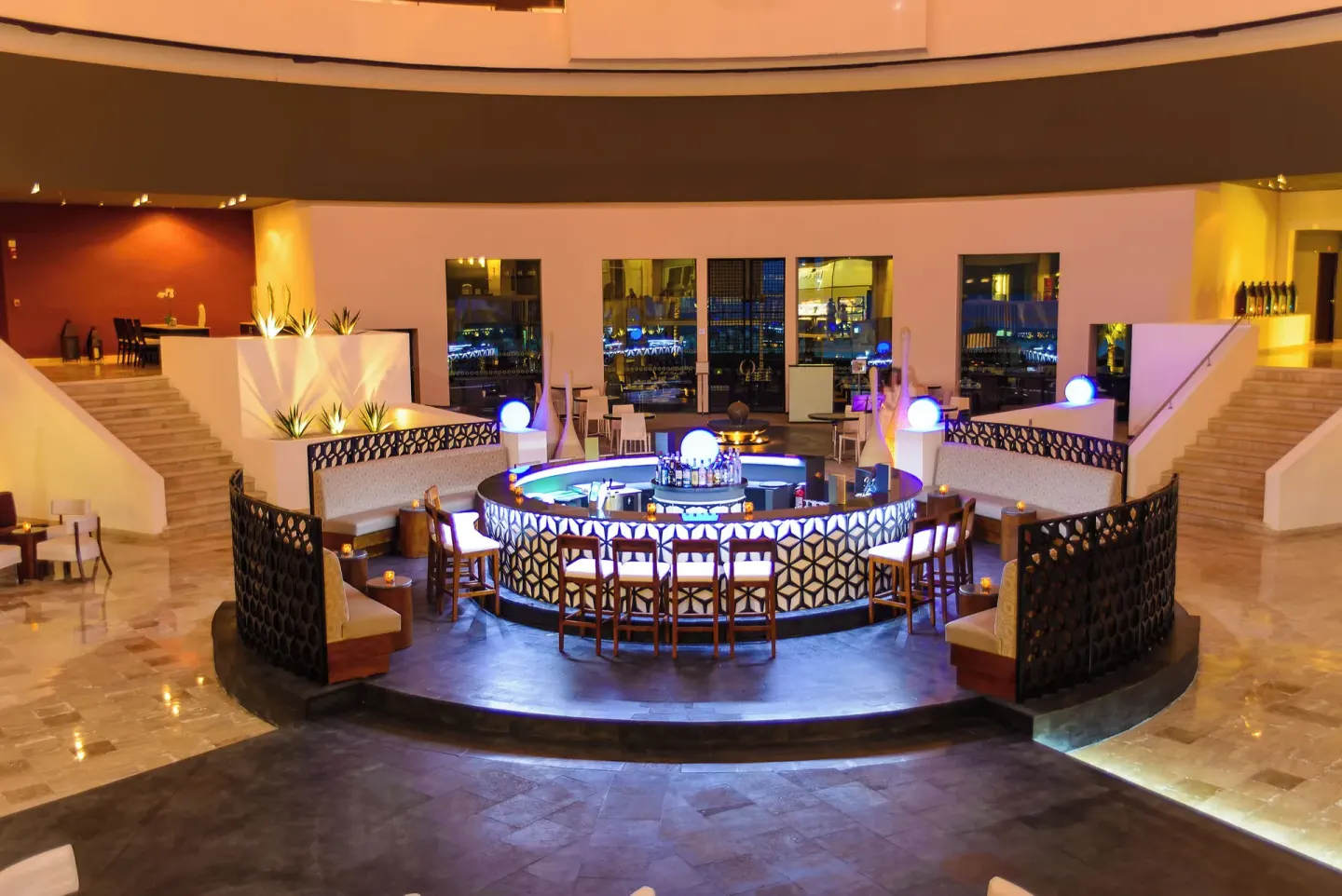 Illuminated circular lobby bar with lounge seating at Krystal Grand Cancun.