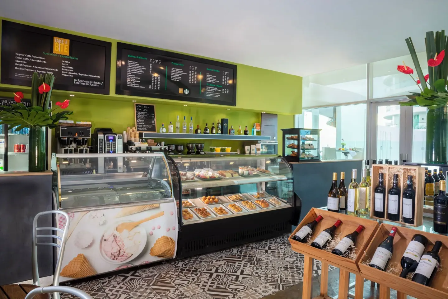 Take a Bite café counter with pastry cases and wine display at Krystal Grand Cancun.