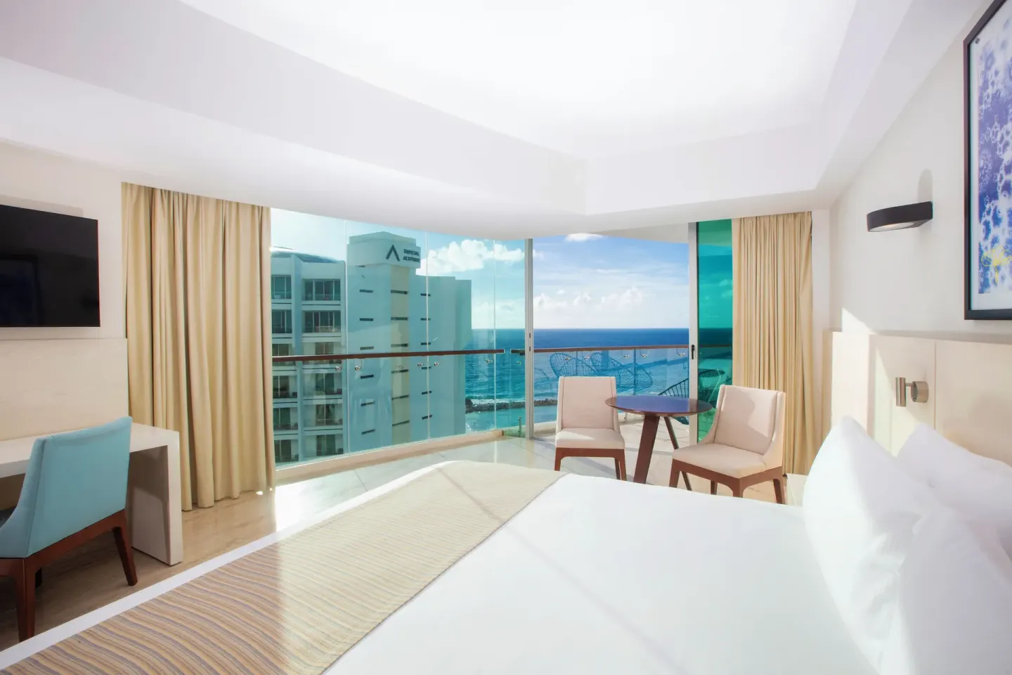 Altitude Corner Suite with king bed and ocean-facing balcony at Krystal Grand Cancun.