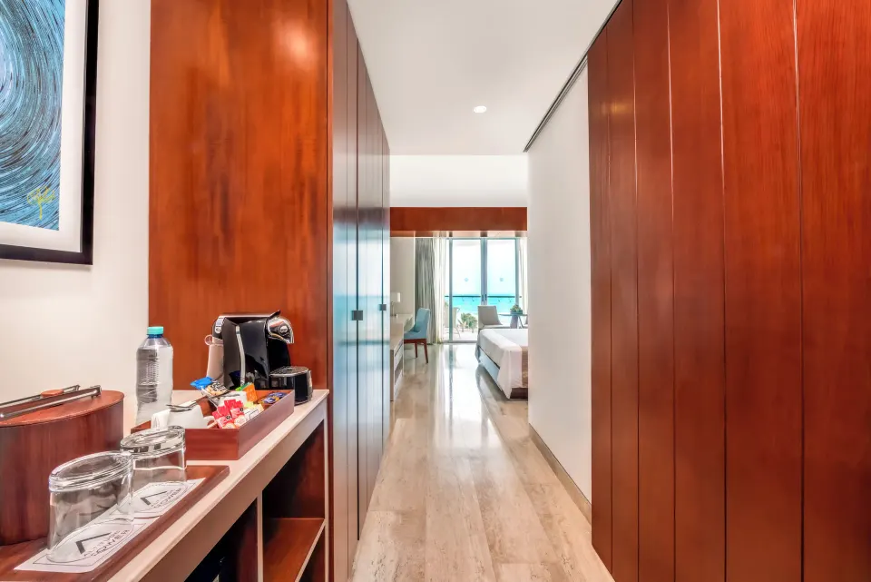 Entry hall with coffee setup leading to an Altitude Suite room at Krystal Grand Cancun.