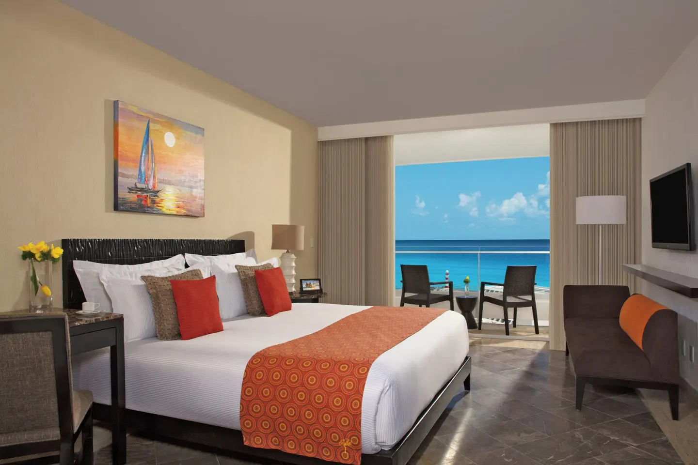 Deluxe Room Ocean View king bed and balcony at Krystal Grand Cancun.