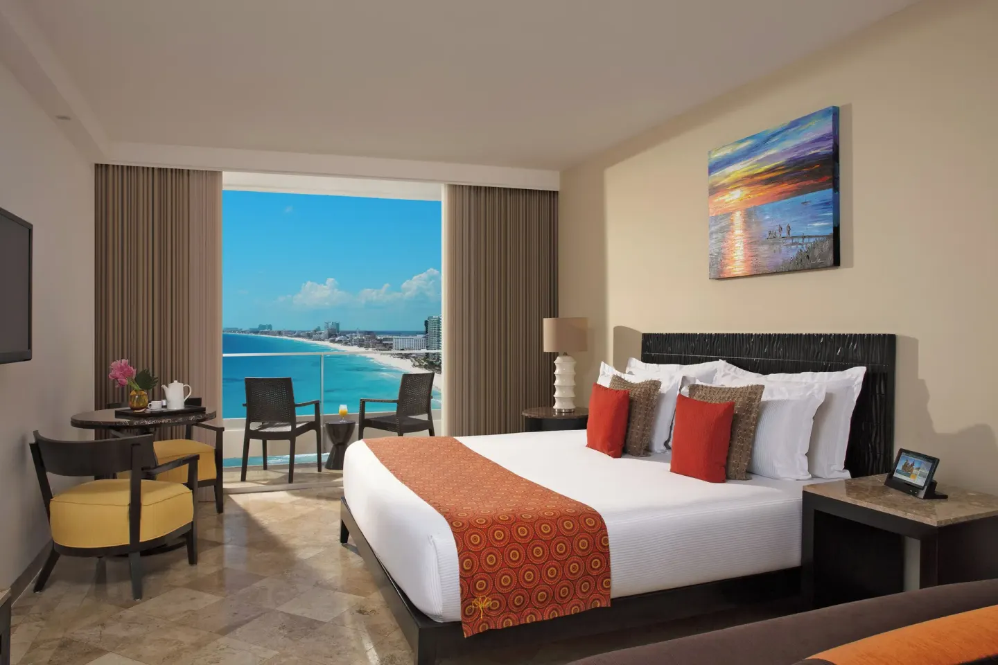 Deluxe Room Ocean View king bed with coastline balcony at Krystal Grand Cancun.