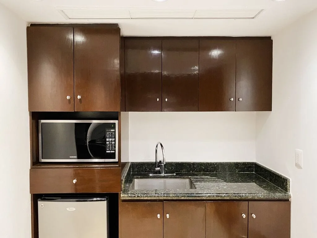 Presidential Room Ocean View kitchenette with sink and cabinets at Krystal Grand Cancun.