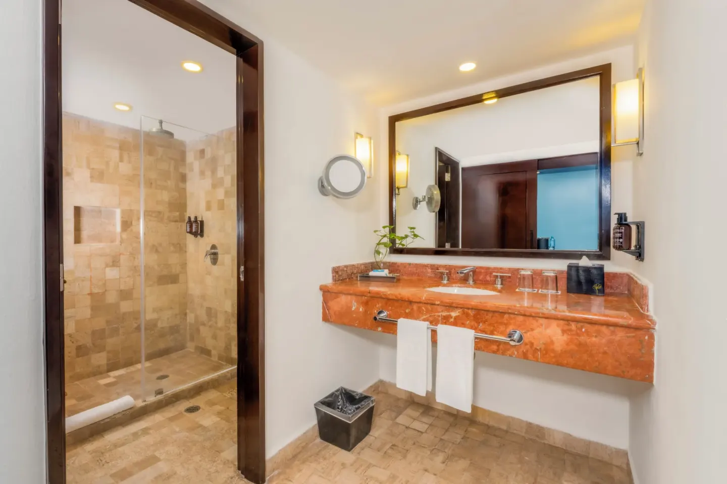 Standard Room bathroom vanity and shower at Krystal Grand Cancun.