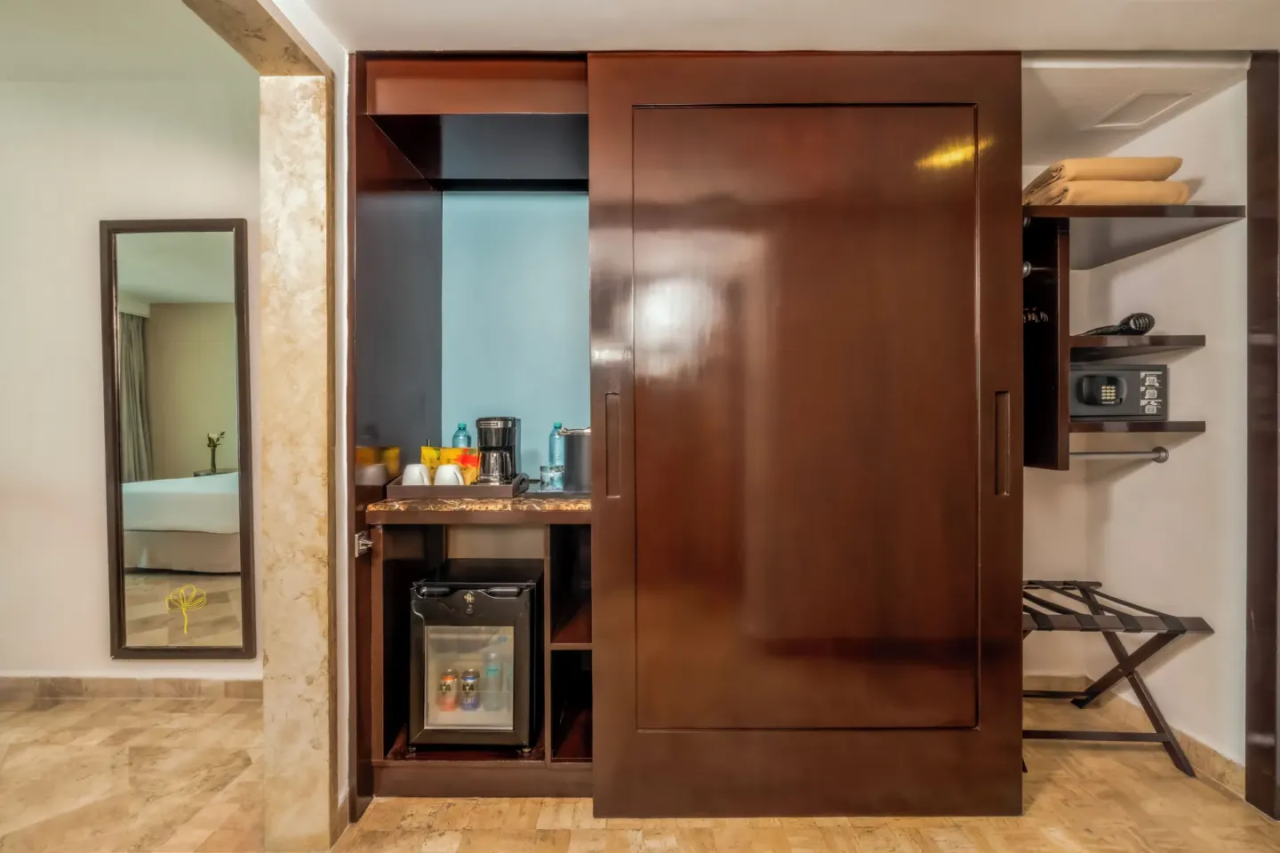 Standard Room closet, minibar, and safe at Krystal Grand Cancun.