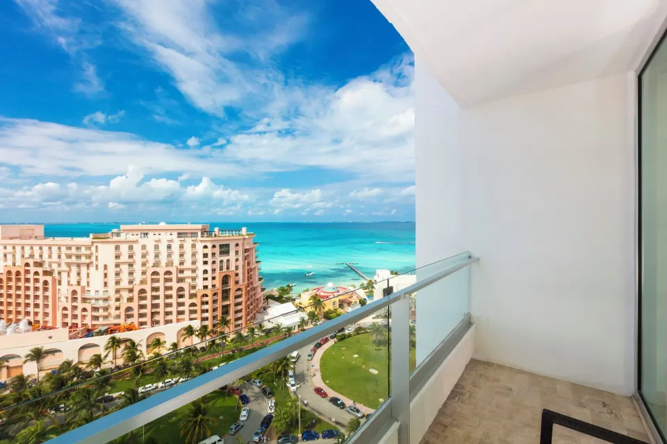 Balcony partial ocean view from a Standard Room at Krystal Grand Cancun.