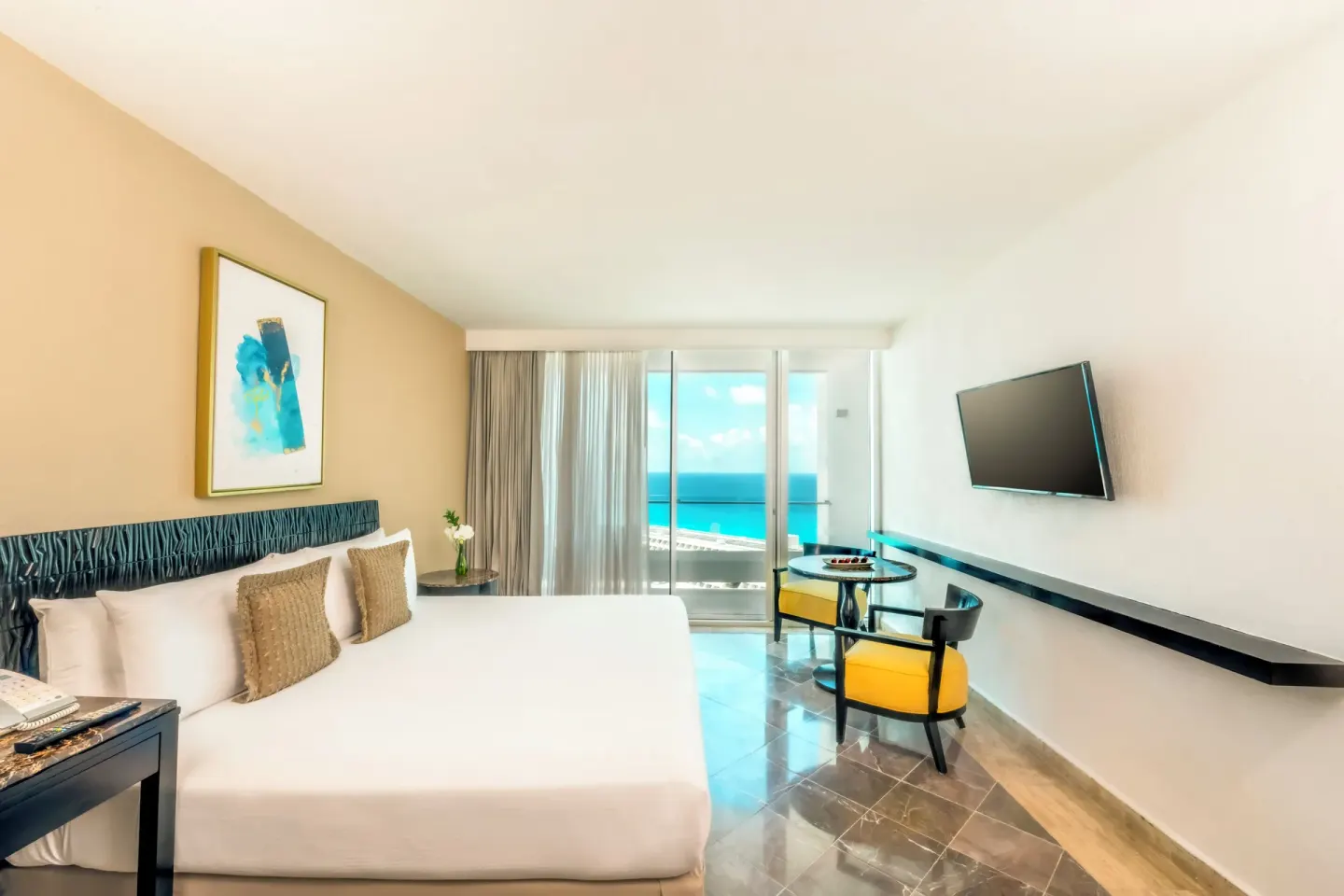Standard Room king bed with balcony partial ocean view at Krystal Grand Cancun.
