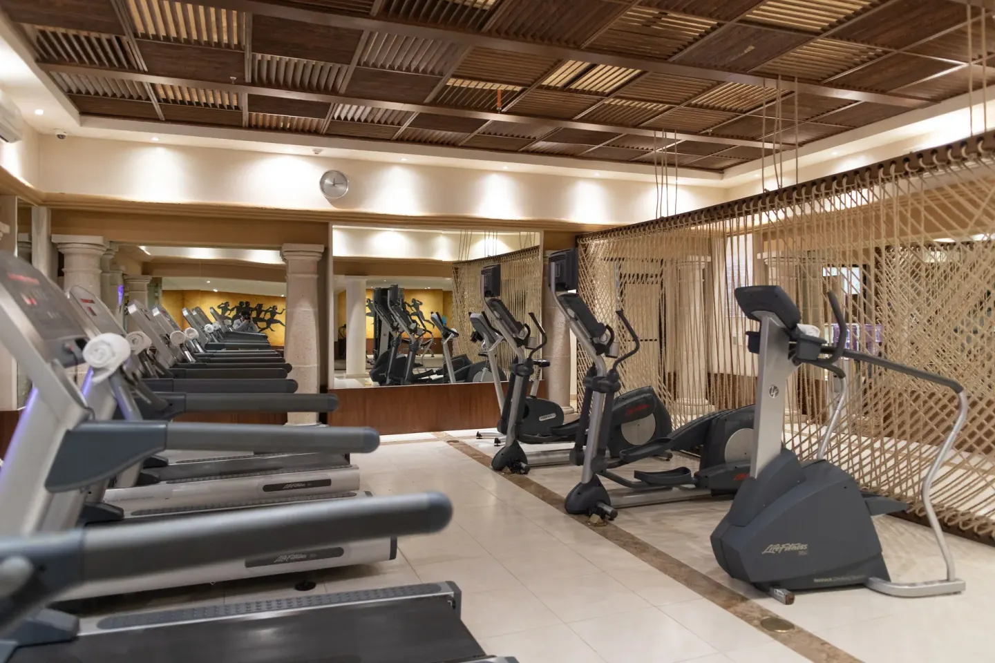 Fitness center with treadmills and exercise bikes at Krystal Grand Los Cabos.