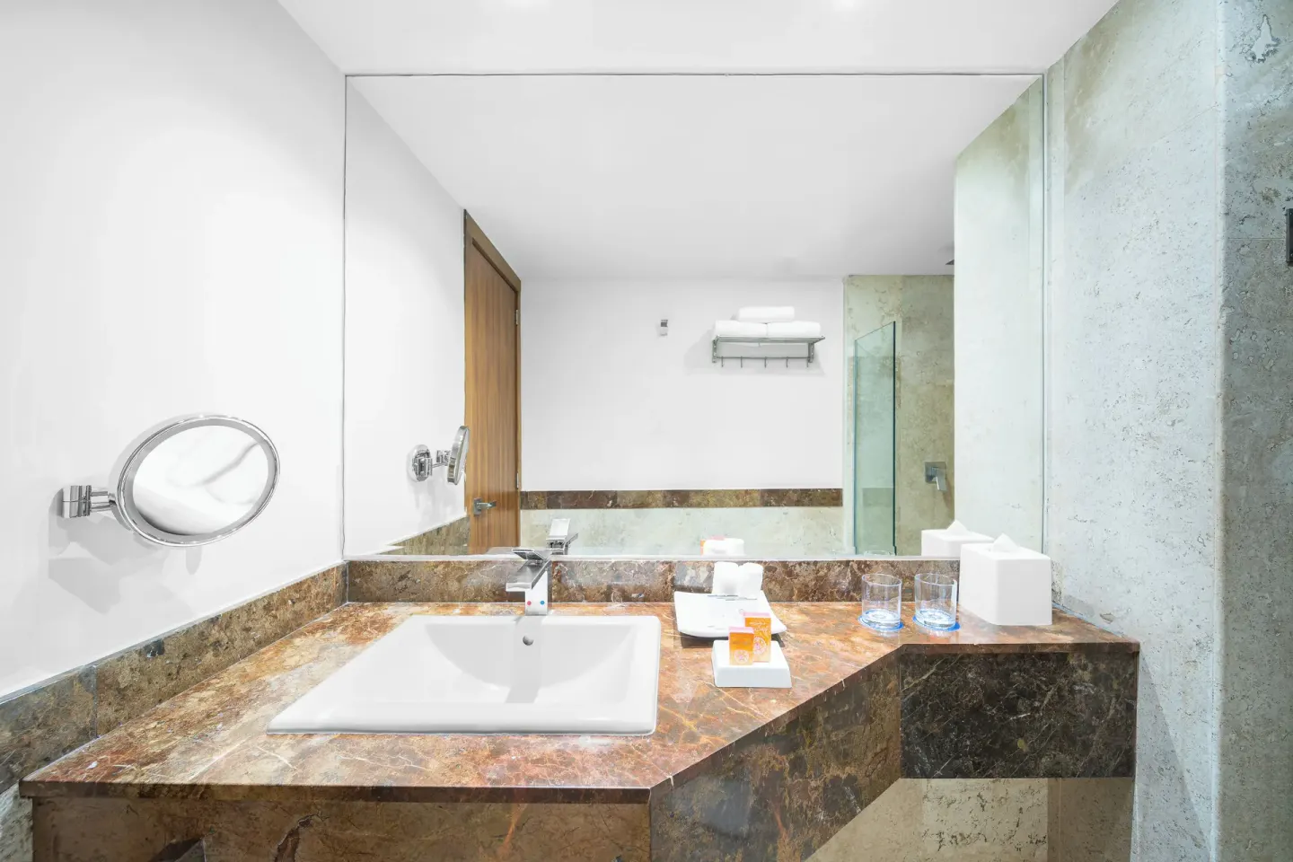 Guest bathroom vanity and glass shower at Krystal Grand Los Cabos.