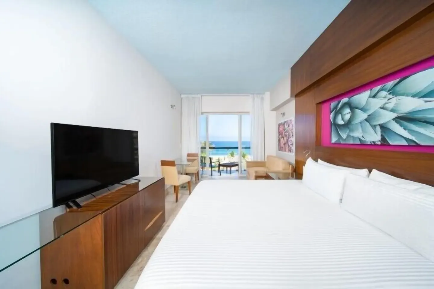 King bed guest room with balcony and ocean view at Krystal Grand Los Cabos.