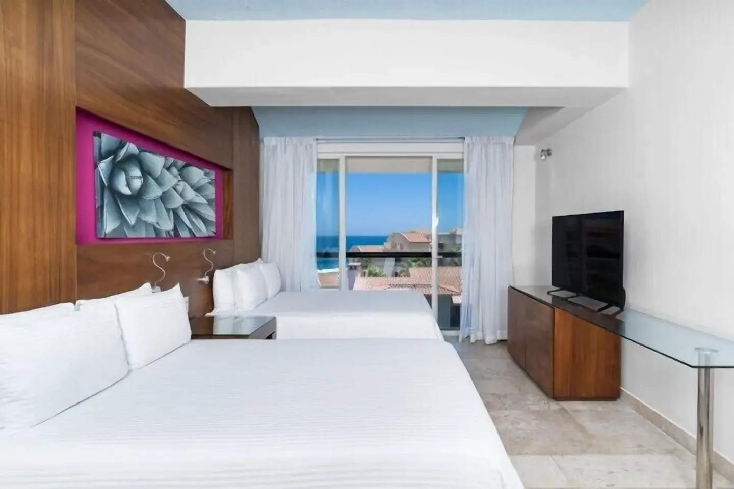 Two-bed guest room with ocean-facing balcony at Krystal Grand Los Cabos.