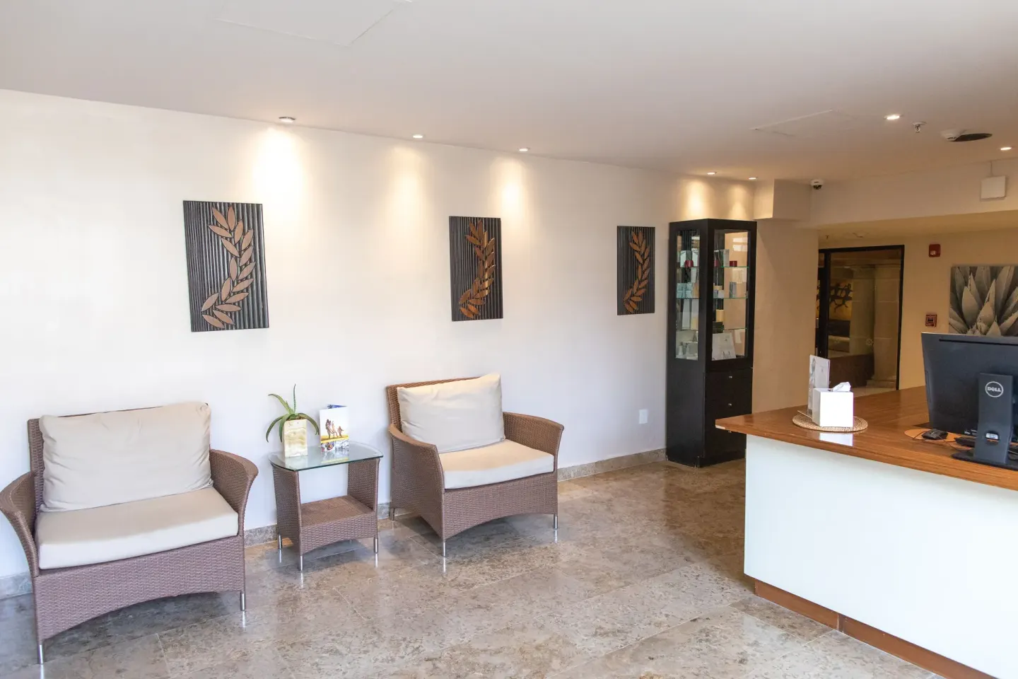 Spa reception area with cushioned chairs and a front desk at Krystal Grand Los Cabos.