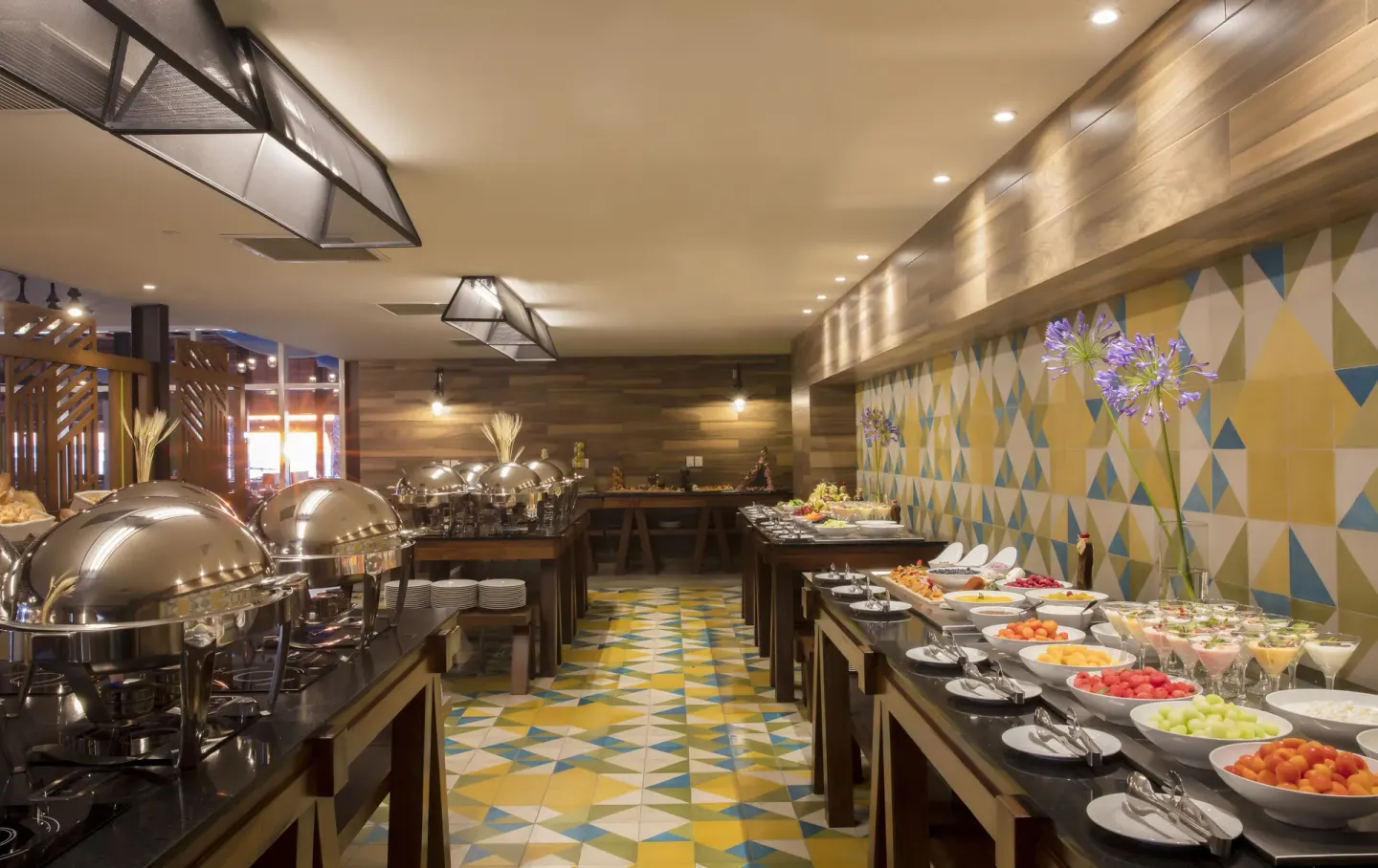 Buffet counters with fruit and hot dishes at Krystal Grand Los Cabos.