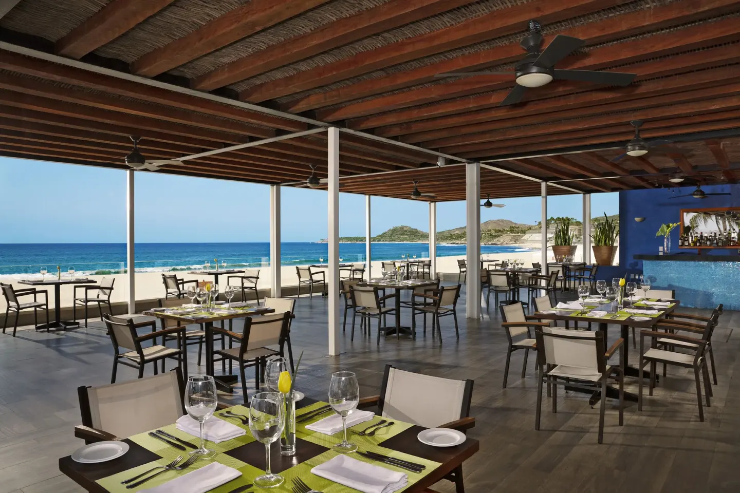 Open-air oceanfront restaurant terrace set for dining at Krystal Grand Los Cabos.