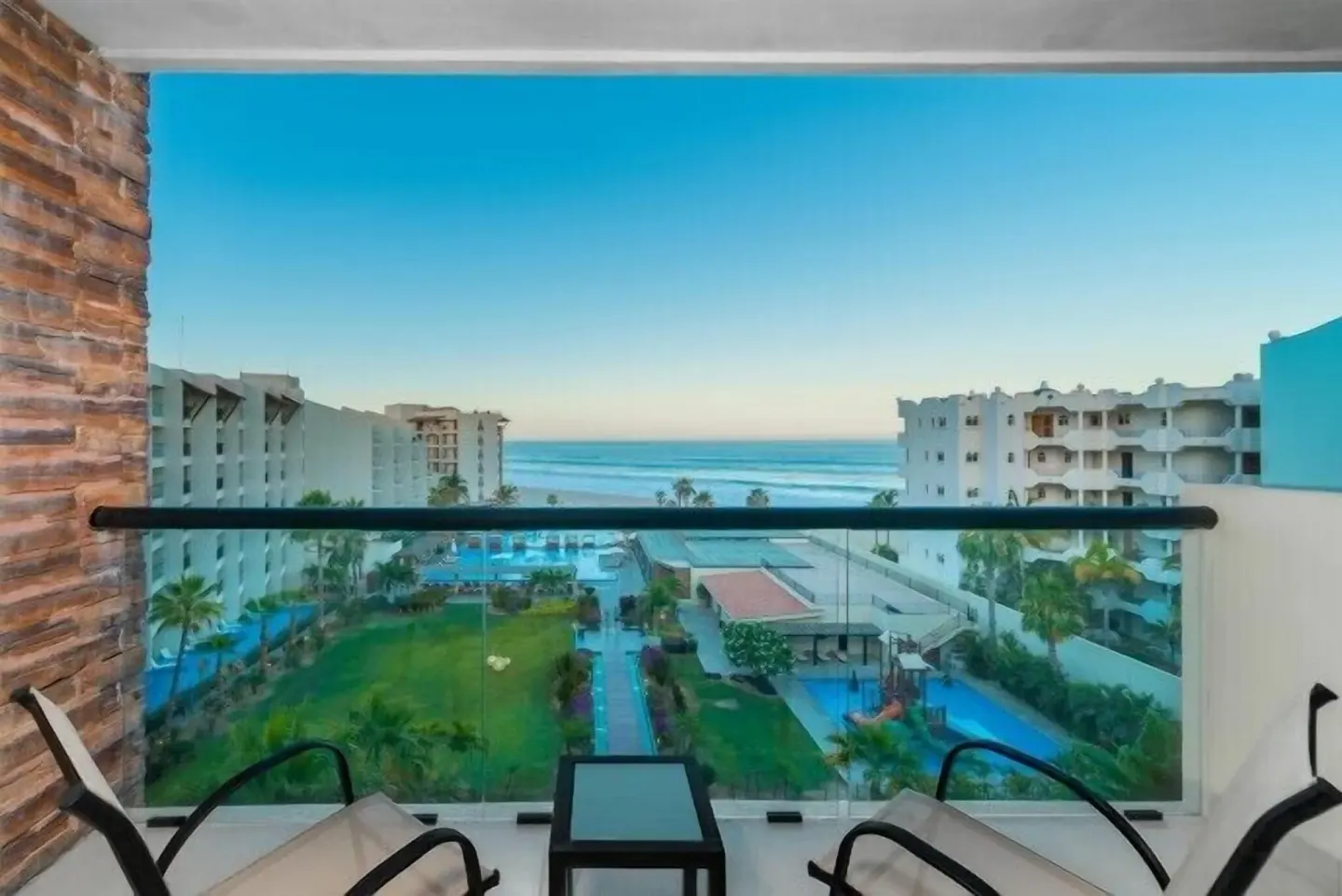 Ocean-view balcony with lounge chairs at Krystal Grand Los Cabos.