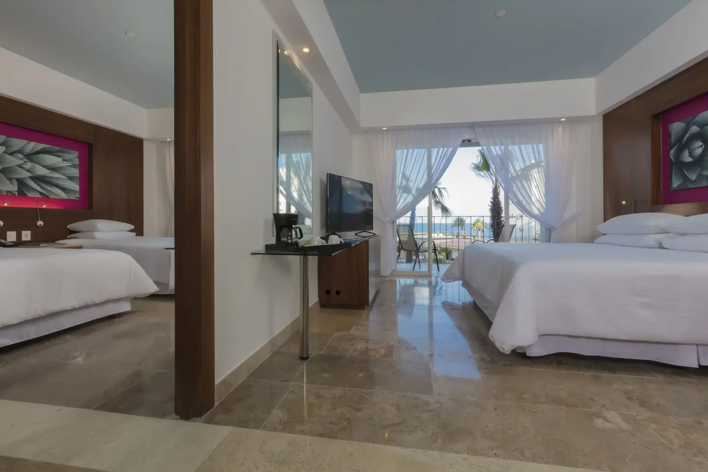 Altitude Governor Suite ocean-view bedroom with balcony doors at Krystal Grand Los Cabos.