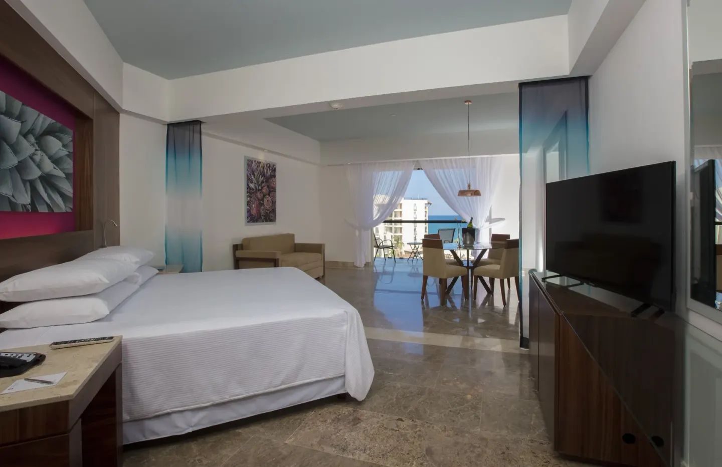 Altitude Governor Suite ocean-view king bedroom and living area at Krystal Grand Los Cabos.