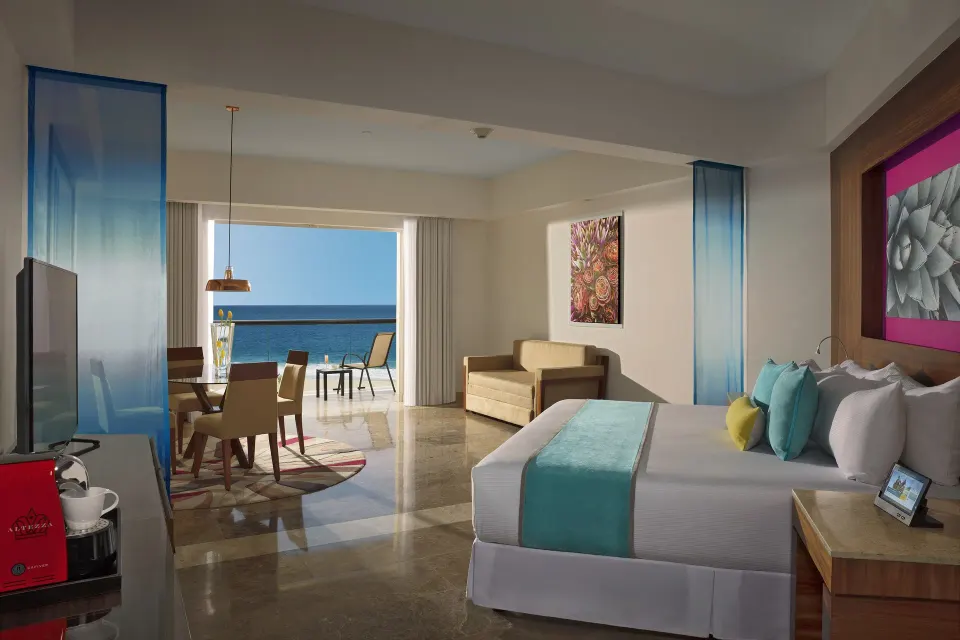 Altitude Governor Suite ocean-view king bed and balcony at Krystal Grand Los Cabos.