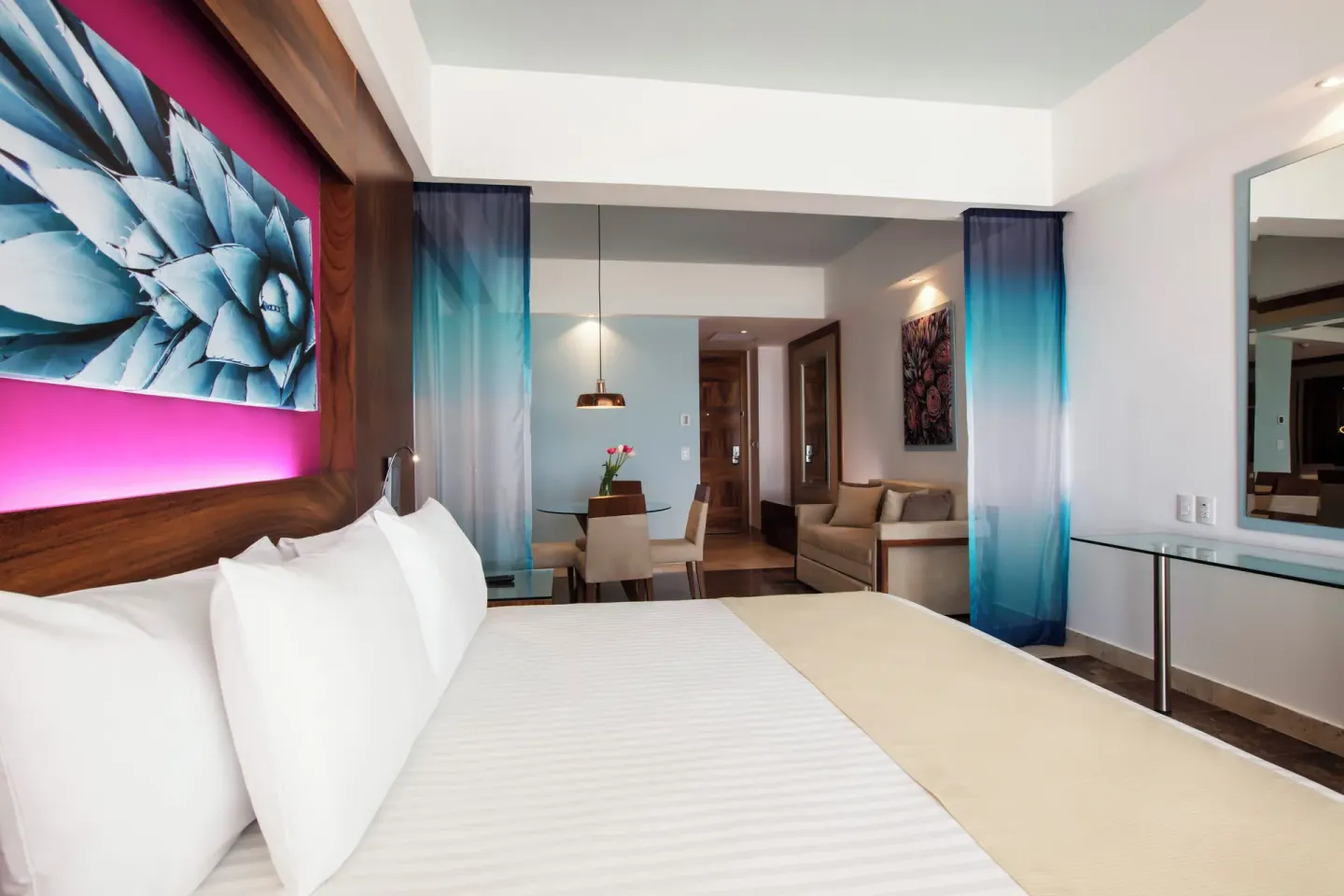 Altitude Junior Suite Ocean Front king bed and dining nook at Krystal Grand Los Cabos.