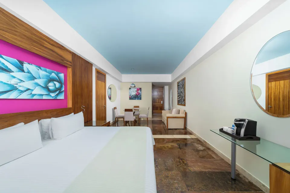 Altitude Junior Suite Ocean Front king bed and room entry at Krystal Grand Los Cabos.